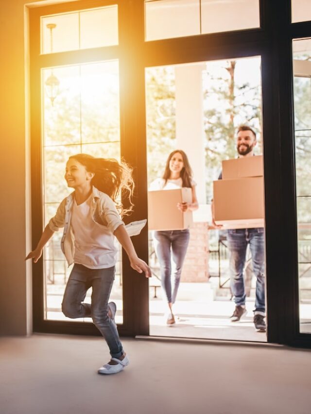 Happy,Family,With,Cardboard,Boxes,In,New,House,At,Moving