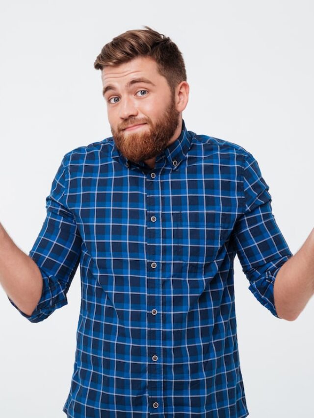 Confused,Young,Bearded,Man,Standing,And,Shrugging,Shoulders,Isolated,Over