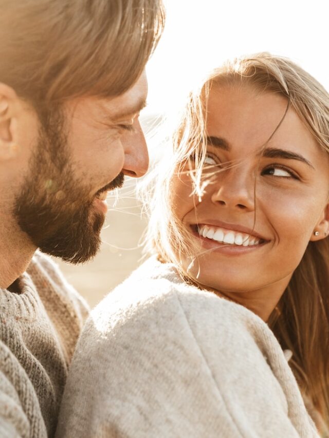 Close,Up,Of,A,Smiling,Beautiful,Young,Couple,Embracing,While