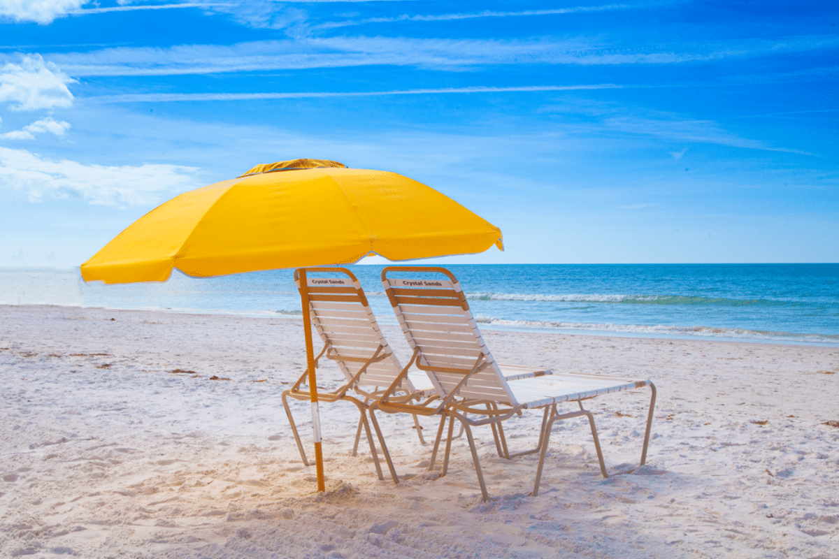 Siesta Key beach with yellow umbrella and chairs